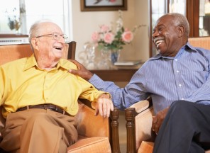 Senior men relaxing in armchairs and laughing together