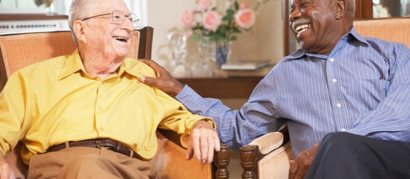 Senior men relaxing in armchairs and laughing together