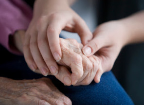 A person holding an elderly hand